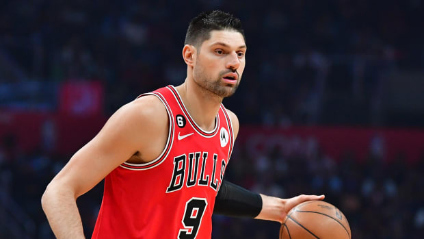 Bulls center Nikola Vucevic dribbles the ball down the court.